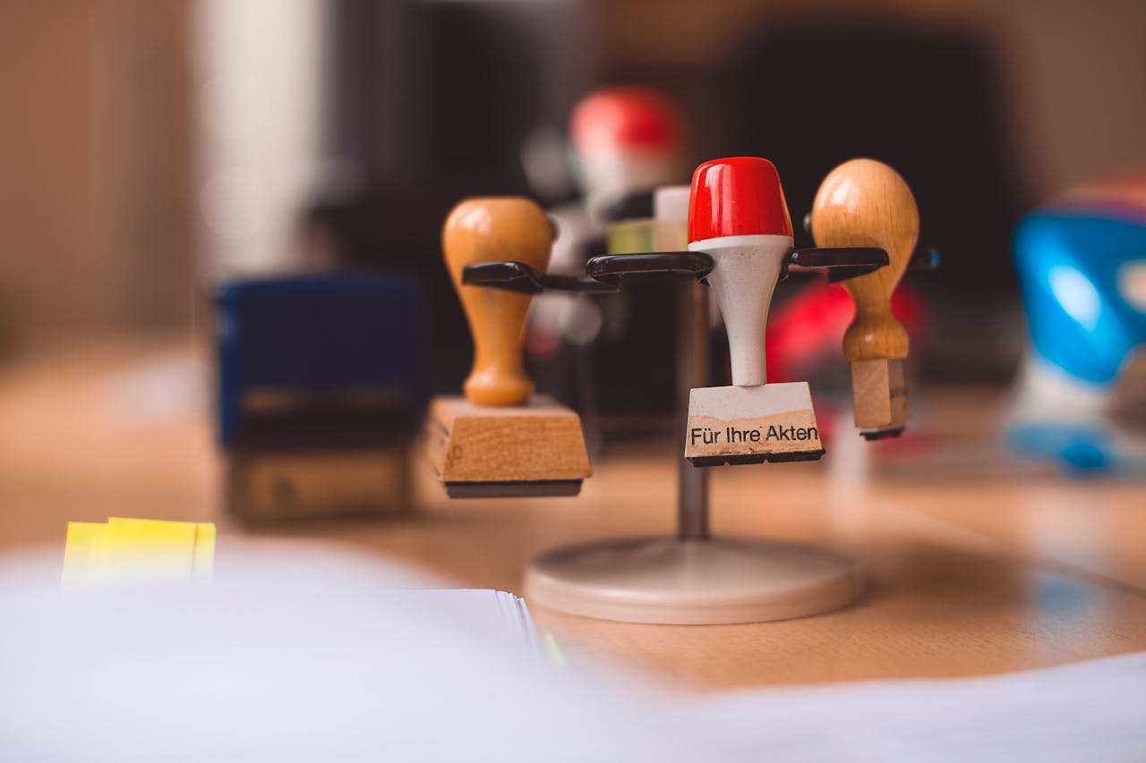 A variety of rubber stamps in selective focus on a wooden table indoors.